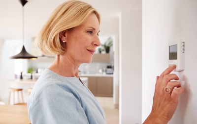 Senior Individual Adjusting AC Settings - AC repair Texas - SouthCoast AC